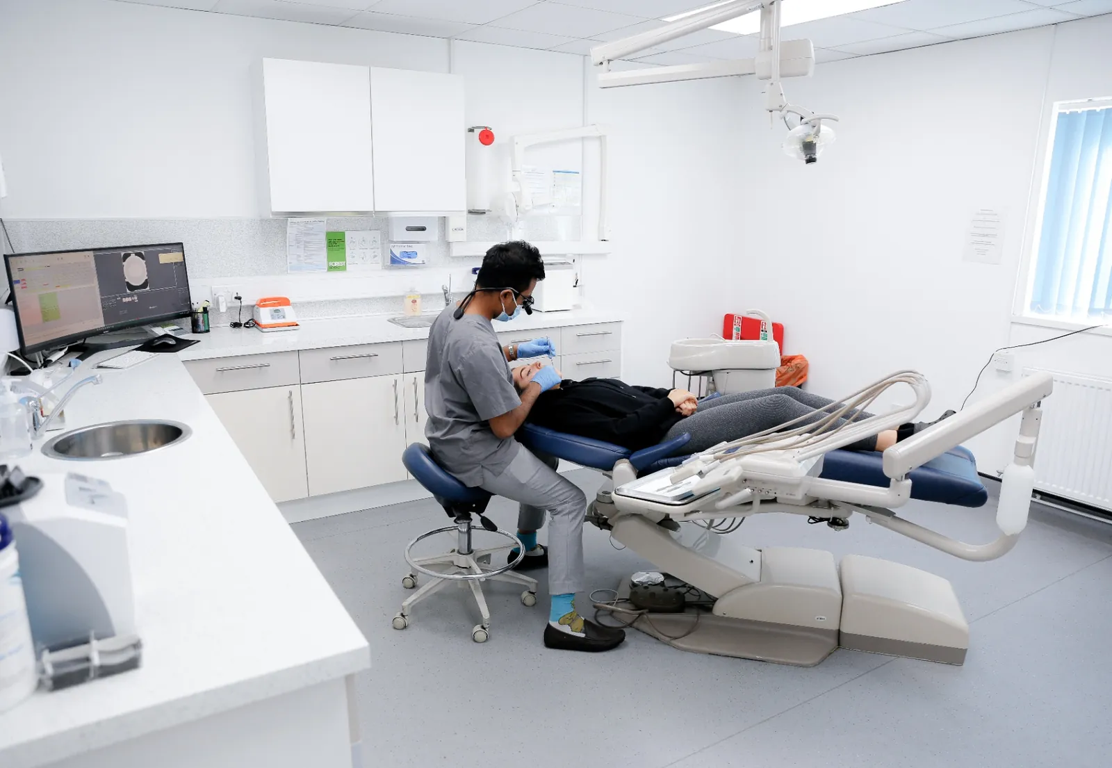 Dr Halima treating a patient in a modern Forest Dental surgery