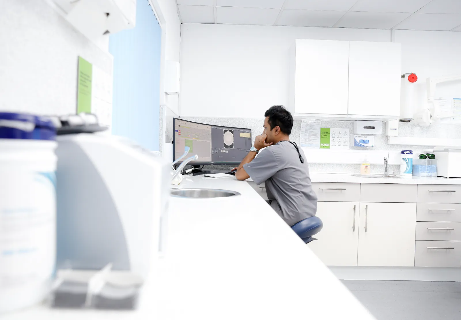 A Forest Dental clinician reviewing a scan in a bright, modern surgery